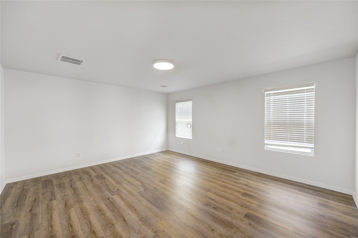 18434 Ranch View Trail Houston, TX 77073 - Photo 30 of 35 an empty room with wooden floor and windows