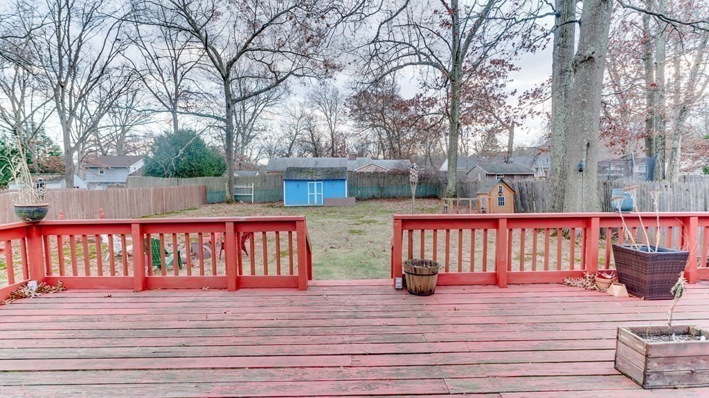 67 Sierra Vista Road Springfield, MA 01128 - Photo 20 of 21 a view of deck with large trees and wooden fence