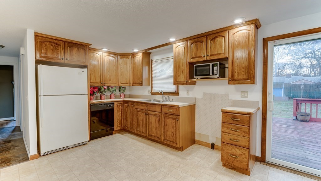 67 Sierra Vista Road Springfield, MA 01128 - Photo 7 of 21 a kitchen with granite countertop a refrigerator stove top oven and sink