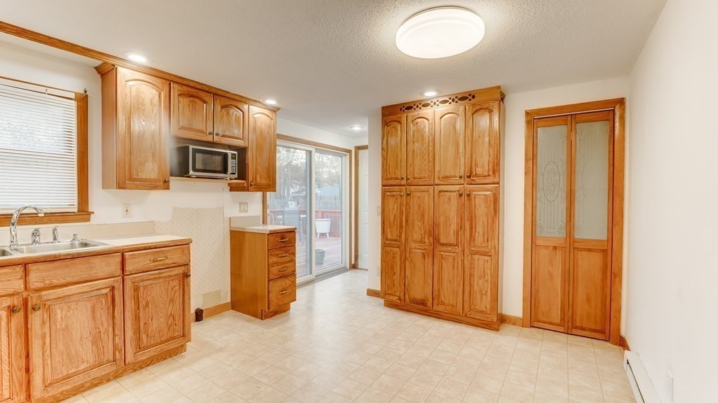 67 Sierra Vista Road Springfield, MA 01128 - Photo 8 of 21 a view of a kitchen with stainless steel appliances wooden floor and a window