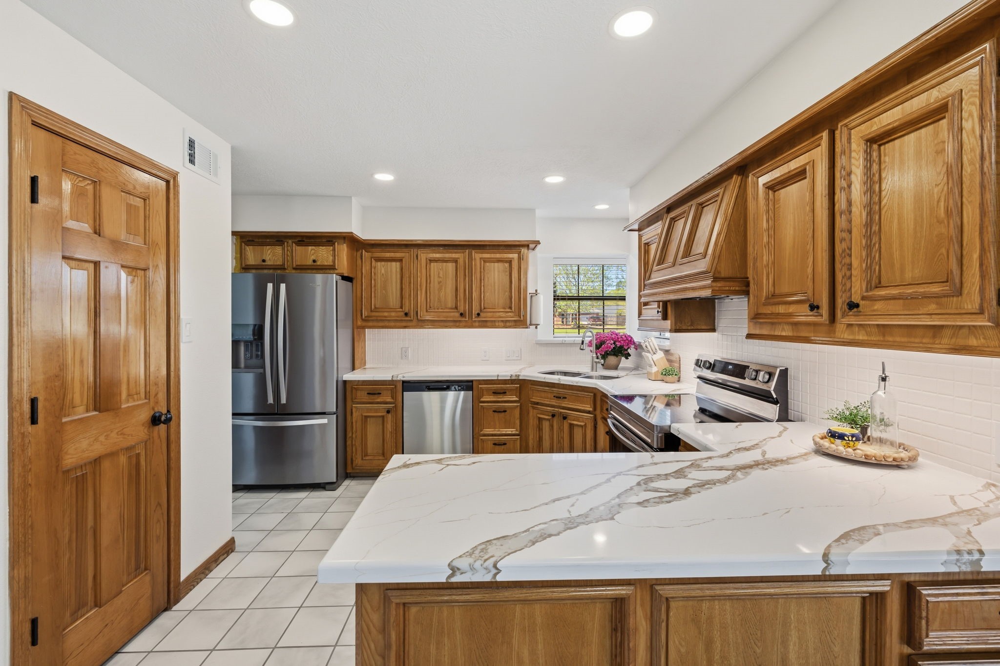 310 Pecan Loop Drive Baytown, TX 77523 - Photo 14 of 43 a kitchen with stainless steel appliances granite countertop a refrigerator sink and cabinets