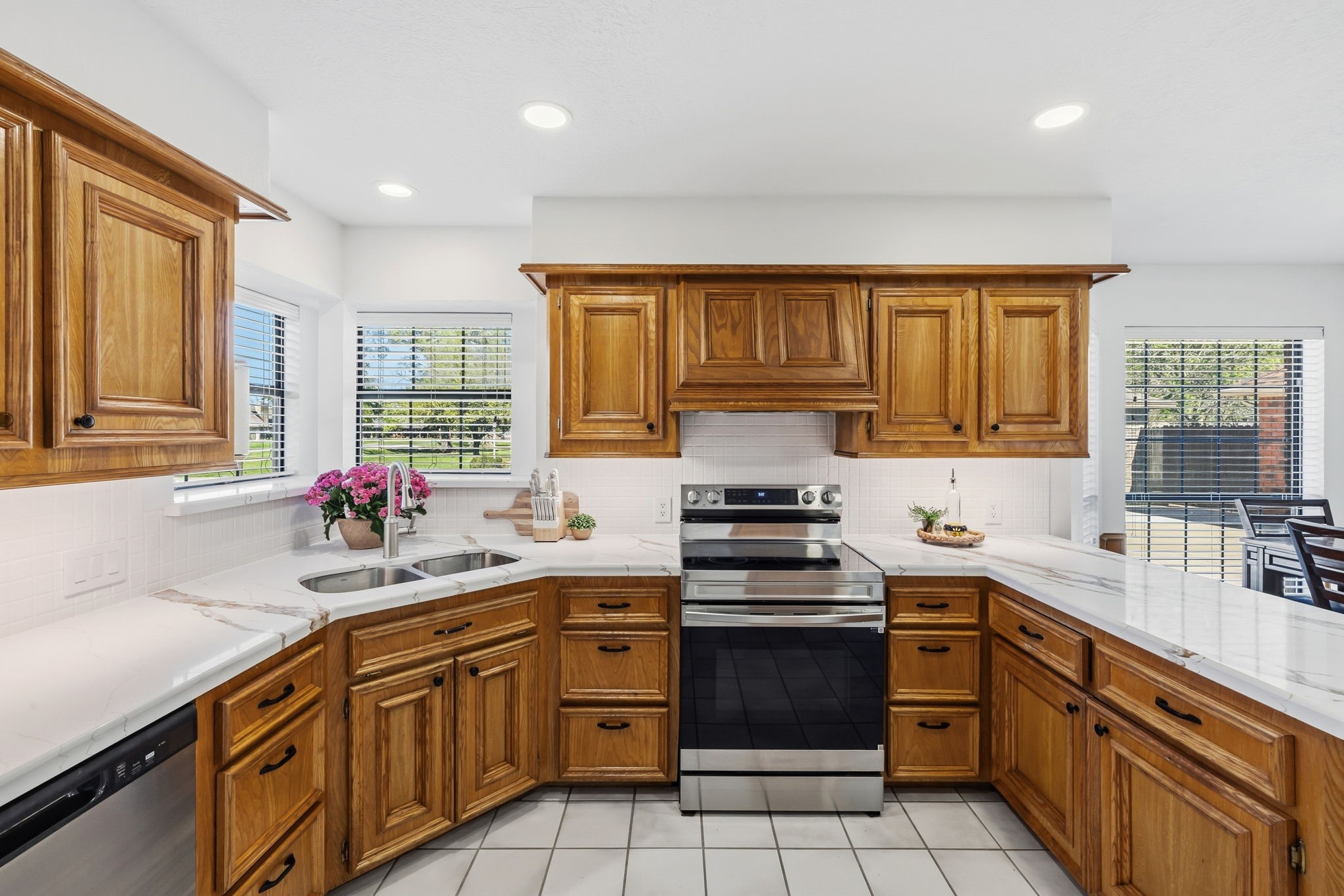 310 Pecan Loop Drive Baytown, TX 77523 - Photo 15 of 43 a kitchen with a sink stove top oven and cabinets