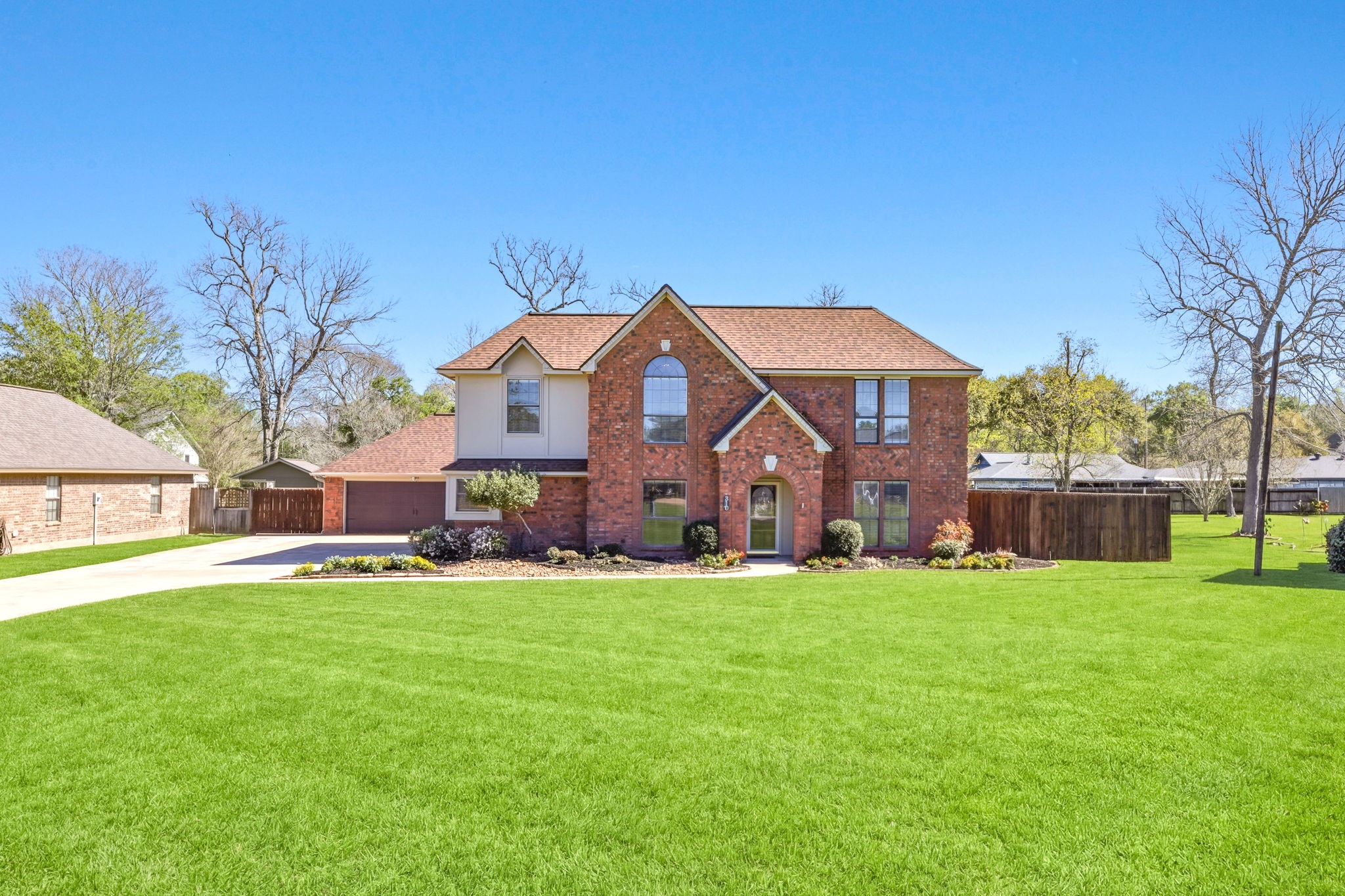 310 Pecan Loop Drive Baytown, TX 77523 - Photo 2 of 43 a front view of a house with a yard and garage