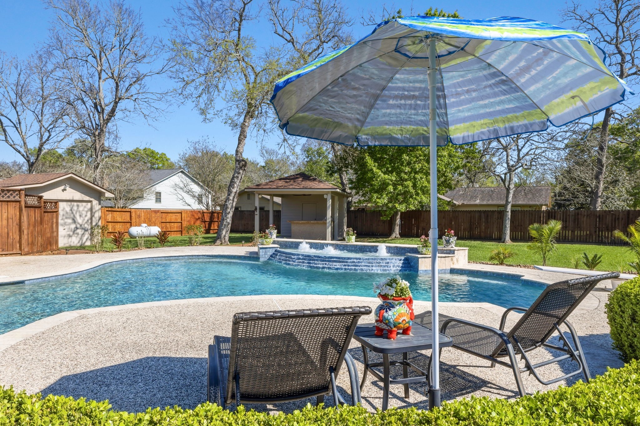 310 Pecan Loop Drive Baytown, TX 77523 - Photo 30 of 43 a patio with a table and chairs under an umbrella