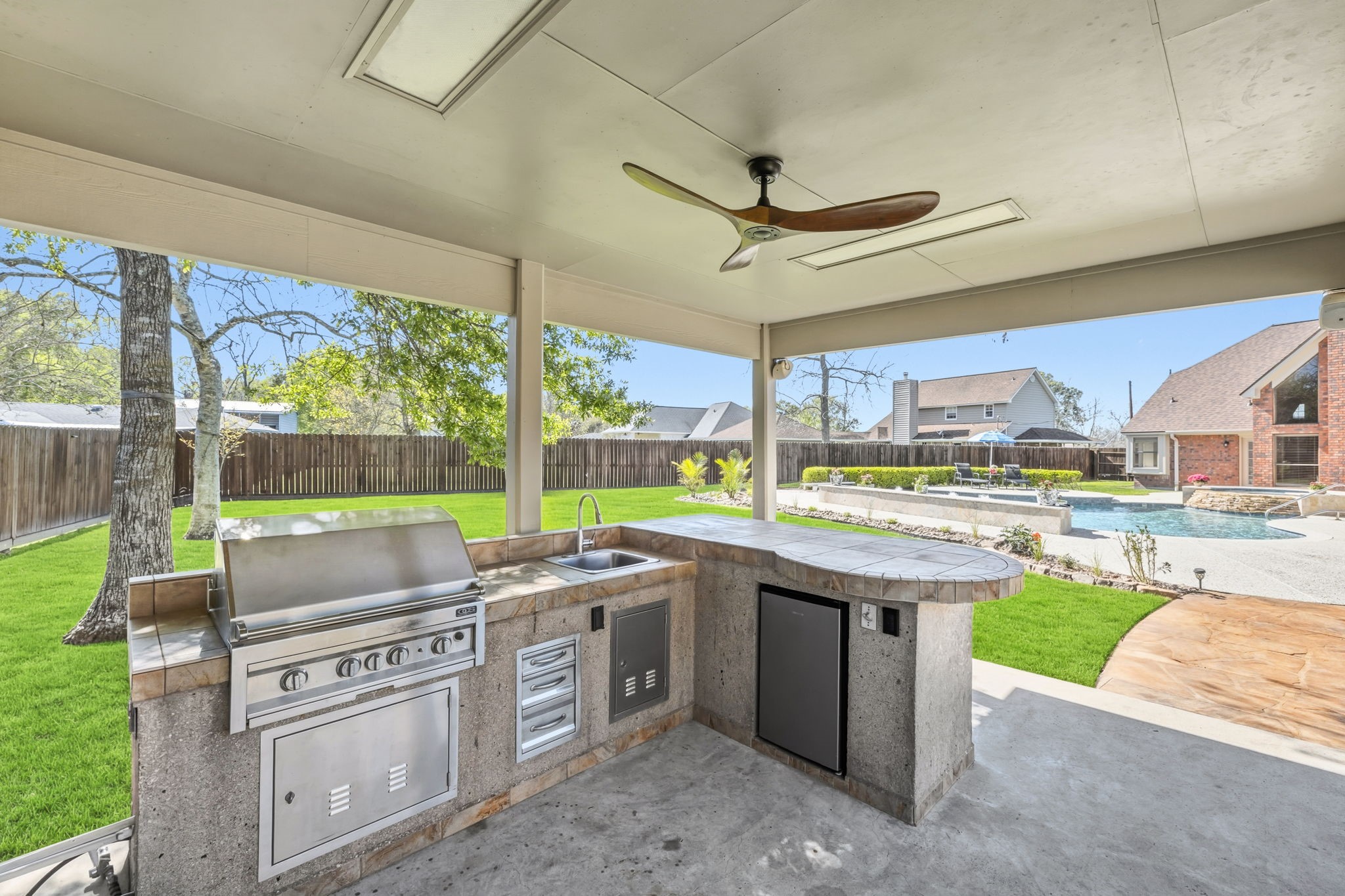 310 Pecan Loop Drive Baytown, TX 77523 - Photo 36 of 43 a open kitchen with a stove and a large window