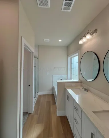 a bathroom with a double vanity sink and a mirror