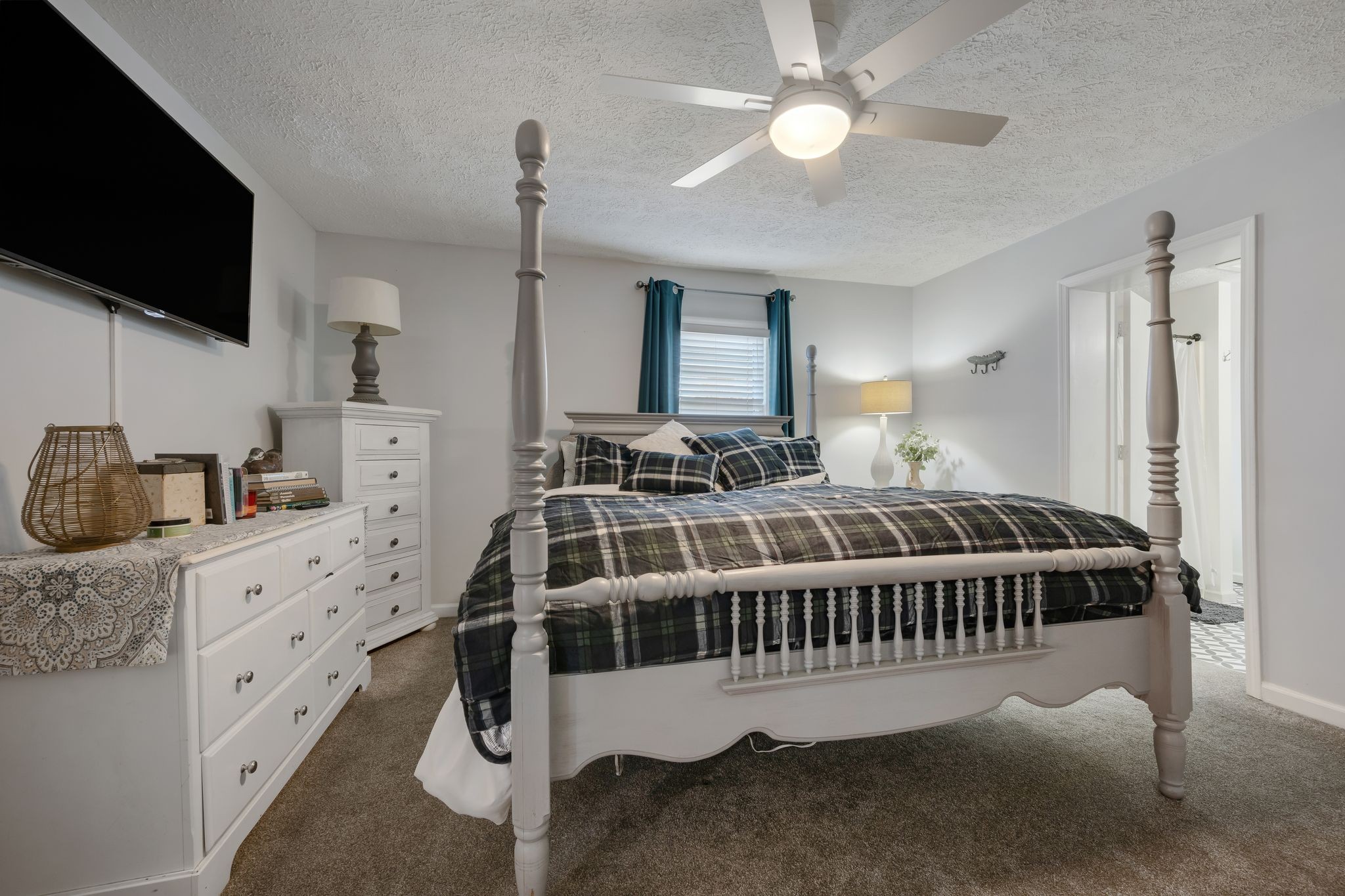 1971 Ridge Road McEwen, TN 37101 - Photo 17 of 40 a bedroom with bed and a flat tv screen on dresser