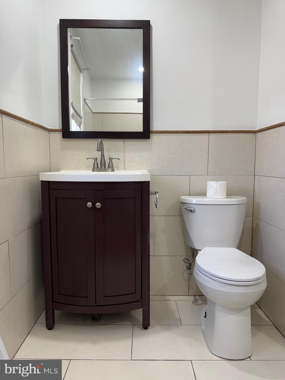 9083 Convent Avenue Philadelphia, PA 19136 - Photo 13 of 22 a bathroom with a toilet sink and mirror