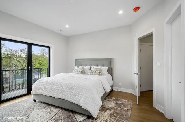 a bedroom with a large bed and a large window