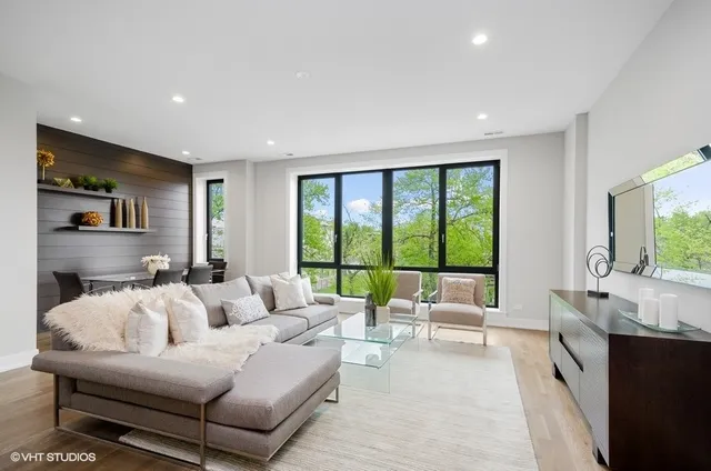a living room with furniture and large windows