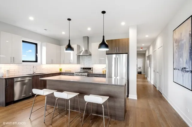 a large kitchen with a table and chairs