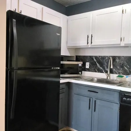 a kitchen with a sink and cabinets