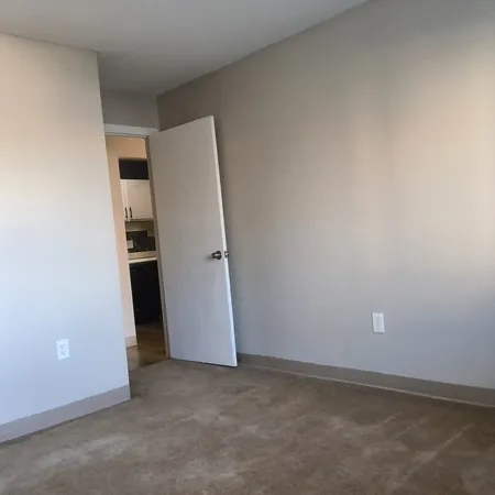 an empty room with closet and a window