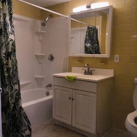 a bathroom with a sink toilet and tub