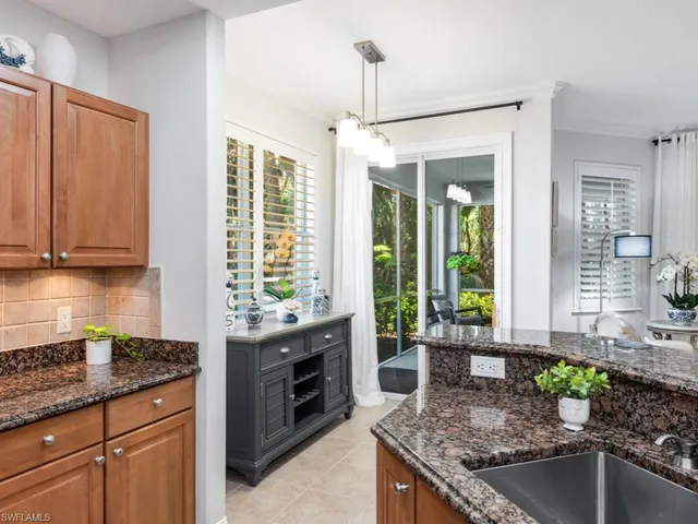 a kitchen with stainless steel appliances granite countertop a sink and a granite counter tops
