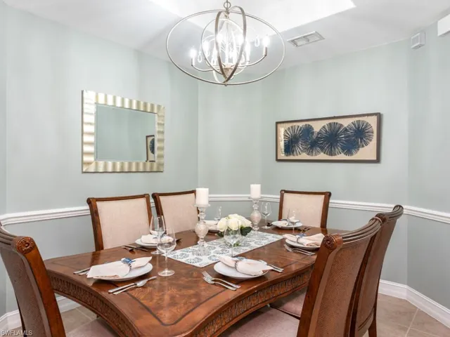 a view of a dining room with furniture wooden floor and a chandelier
