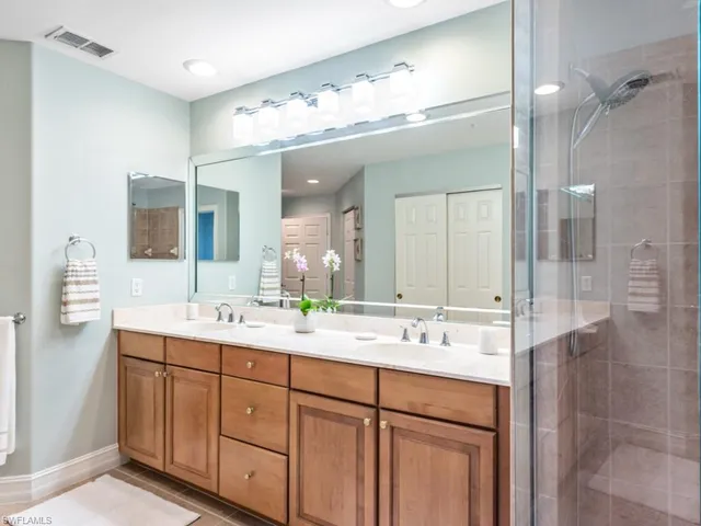 a bathroom with a double vanity sink mirror and double