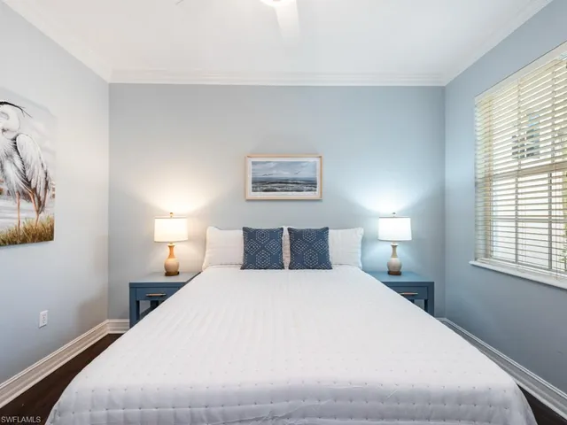 a bedroom with a large bed and a lamp