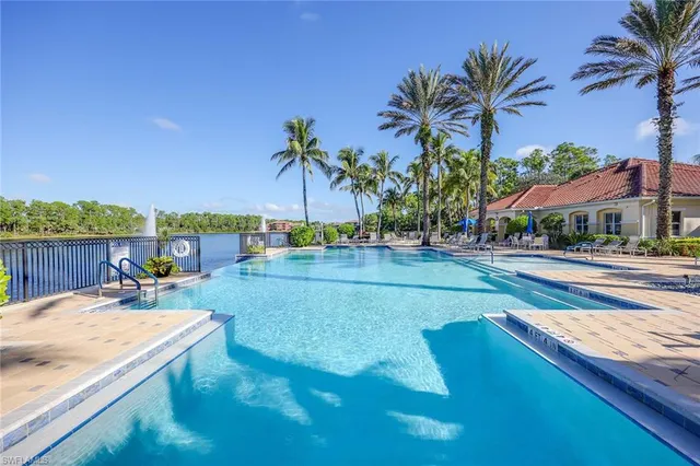 a view of a swimming pool with a patio and a yard