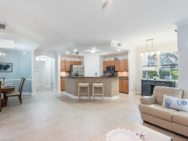 a living room with furniture and kitchen view
