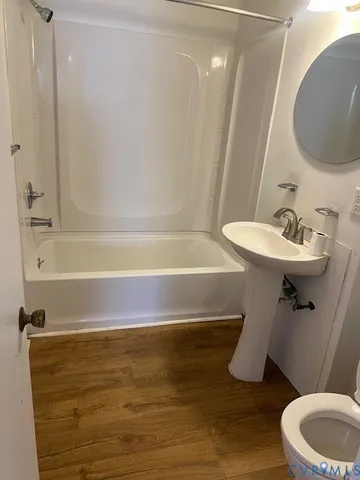 a bathroom with a sink a toilet and bathtub