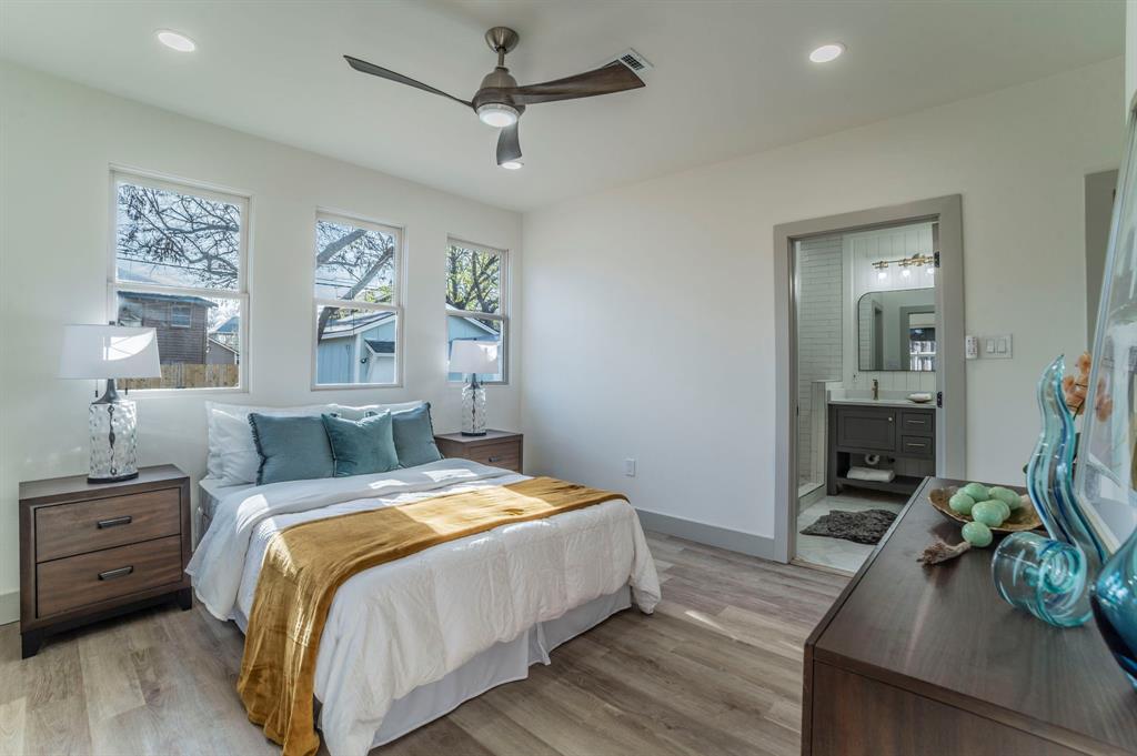 5914 Victor Street Dallas, TX 75214 - Photo 13 of 32 a bedroom with a bed and wooden floor
