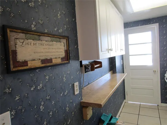a kitchen with a refrigerator and cabinets