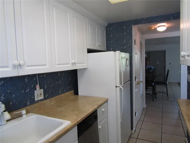 a kitchen with stainless steel appliances granite countertop white cabinets and a granite counter tops