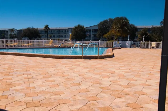a view of swimming pool with outdoor seating