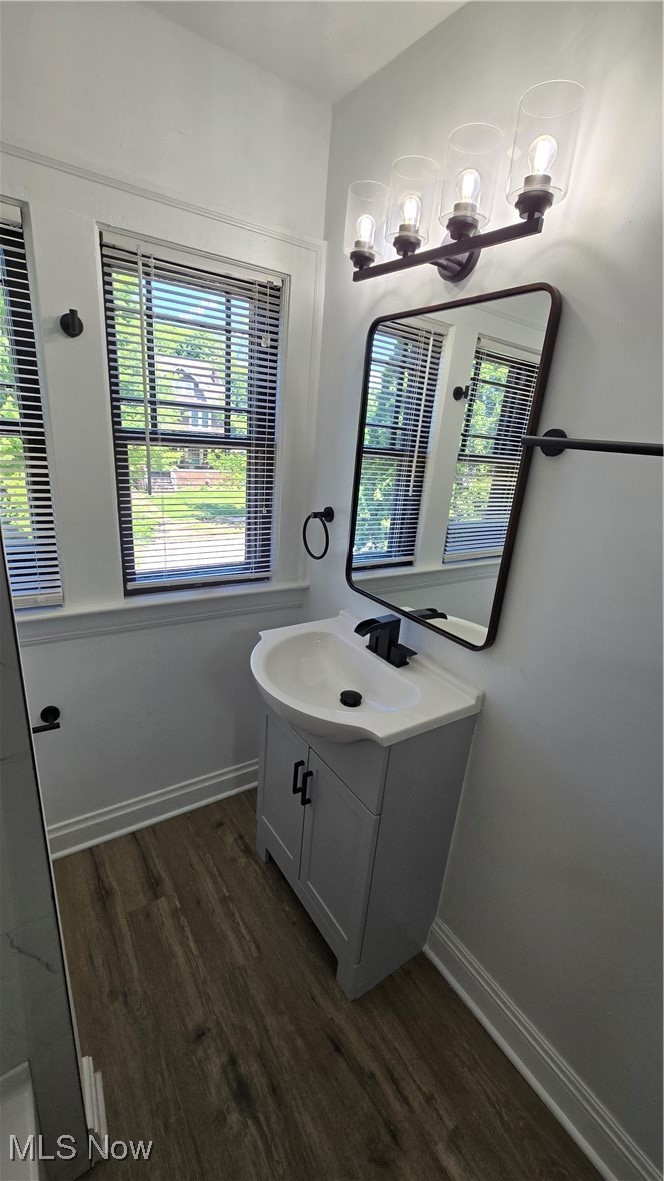 3388 Cedarbrook Road Cleveland, OH 44118 - Photo 8 of 14 Bathroom featuring wood finished floors, vanity, baseboards, and a chandelier