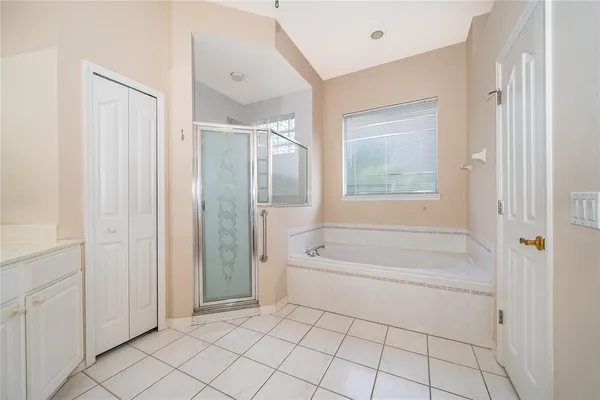 a spacious bathroom with a bathtub and a shower