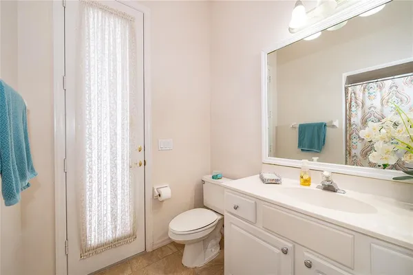 a bathroom with a sink vanity granite and toilet