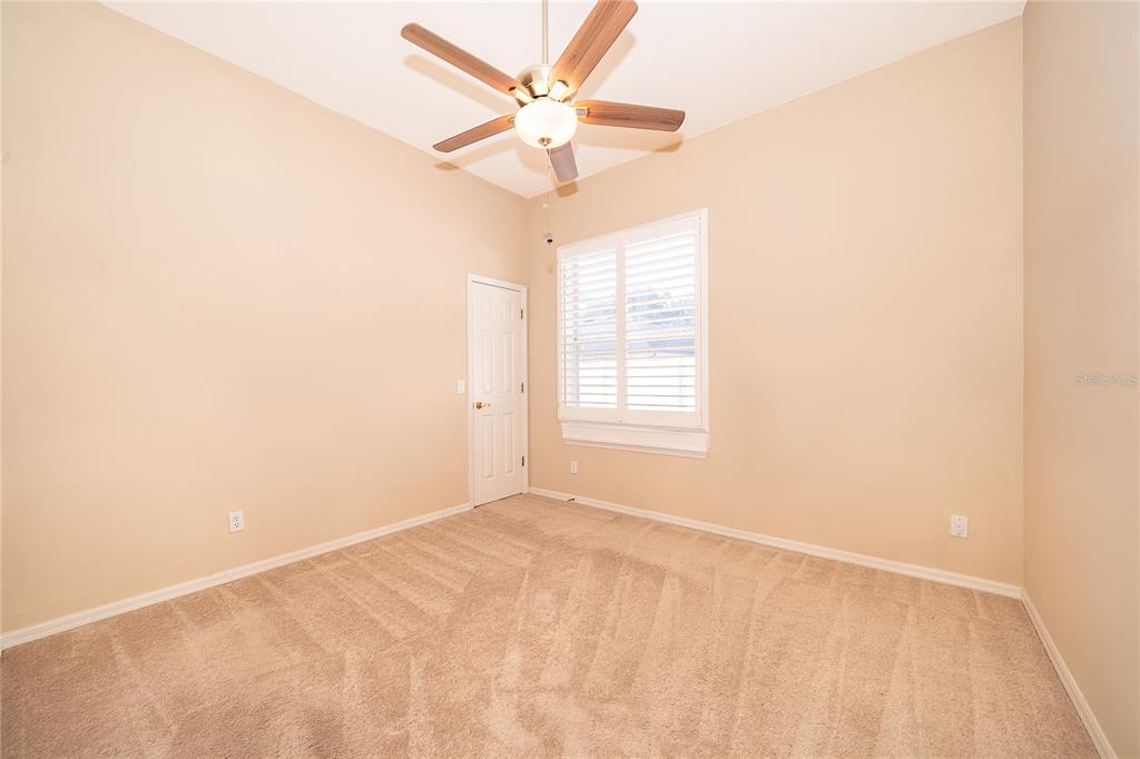 2277 Nectar Way Oviedo, FL 32765 - Photo 21 of 30 an empty room with a window and a fan