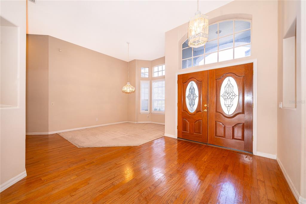 2277 Nectar Way Oviedo, FL 32765 - Photo 3 of 30 a view of an empty room with wooden floor and a window