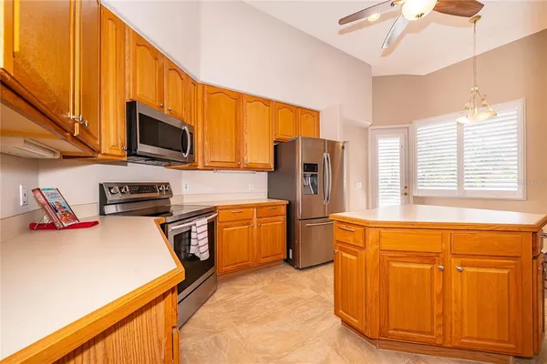 a kitchen with stainless steel appliances granite countertop a refrigerator a stove top oven a sink and dishwasher