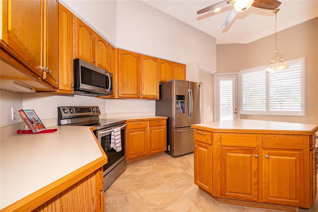 2277 Nectar Way Oviedo, FL 32765 - Photo 6 of 30 a kitchen with stainless steel appliances granite countertop a refrigerator a stove top oven a sink and dishwasher