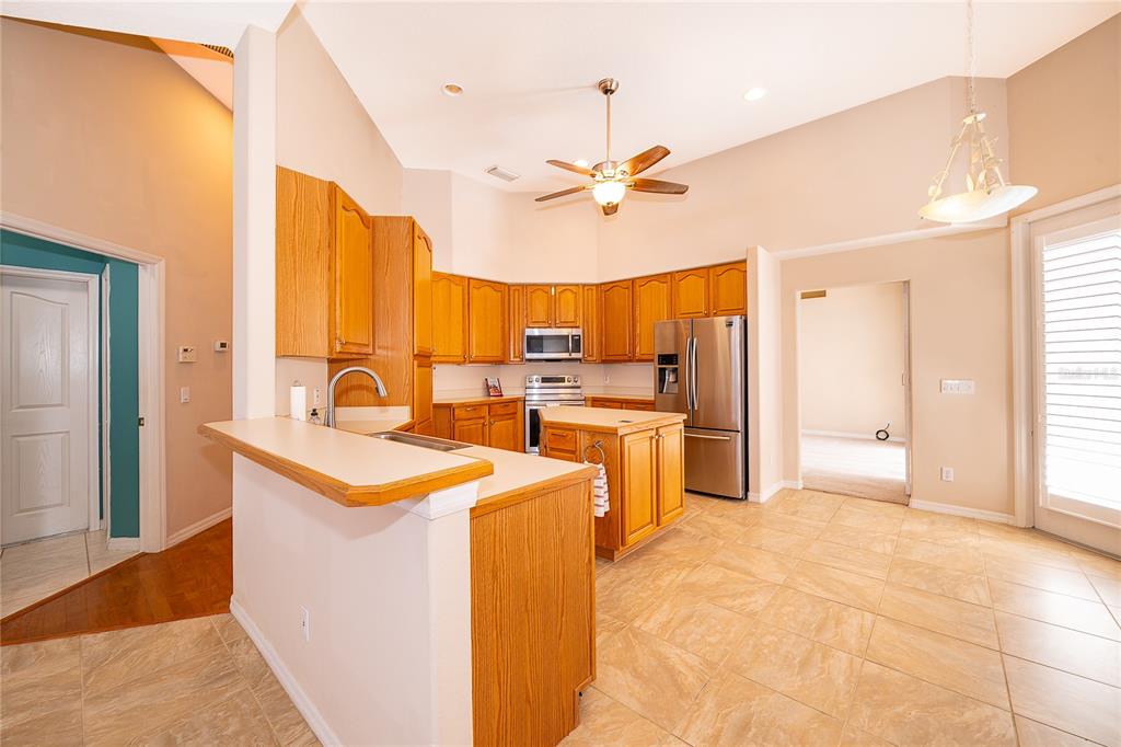 2277 Nectar Way Oviedo, FL 32765 - Photo 9 of 30 a kitchen with sink refrigerator and cabinets