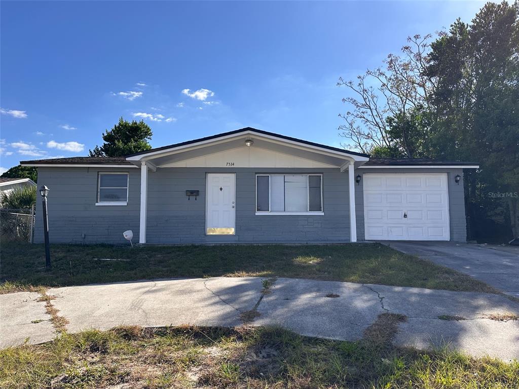 7534 Venice Drive Port Richey, FL 34668 - Photo 1 of 1 a front view of a house with a yard