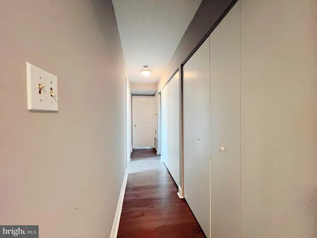 a view of a hallway with wooden floor