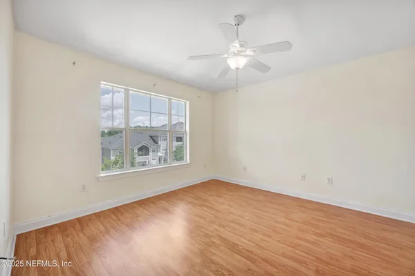 a view of empty room with wooden floor