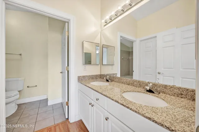 a white toilet sitting next to a bath tub