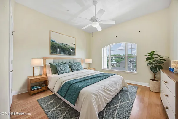 an empty room with wooden floor and window