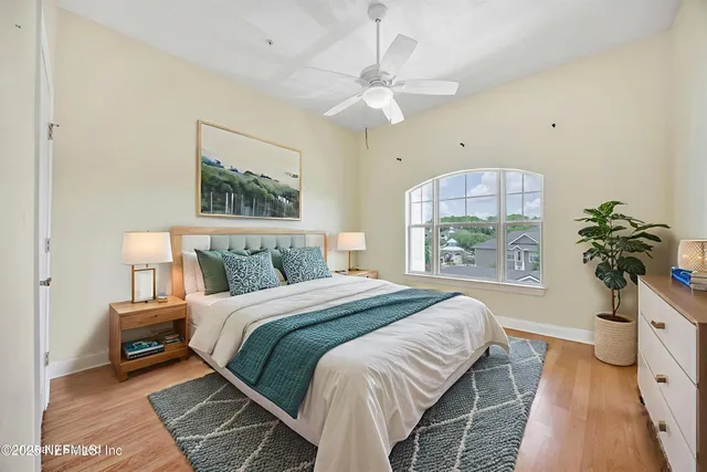 an empty room with wooden floor and window