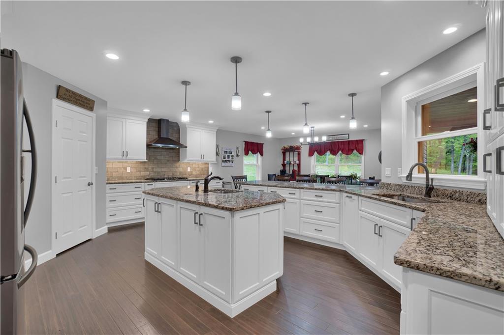 560 Bash Road Indiana, PA 15701 - Photo 6 of 25 a kitchen with granite countertop white cabinets and refrigerator