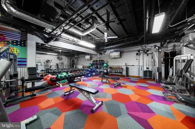 a view of gym equipment with clothes and shoes