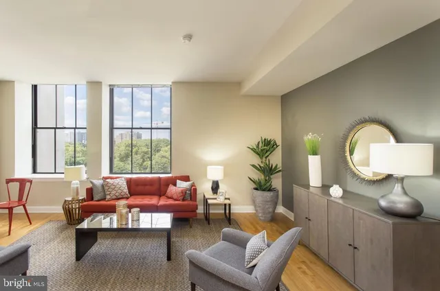 a living room with furniture and a large window
