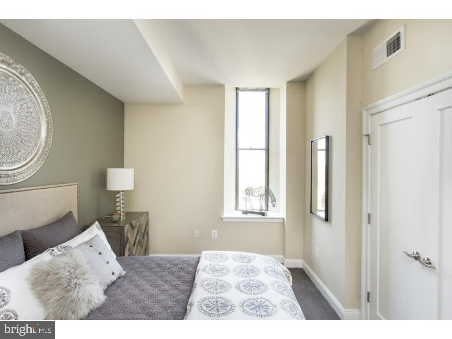 230-38 North 21st Street, Unit 604 Philadelphia, PA 19103 - Photo 7 of 20 a bedroom with a bed and a window