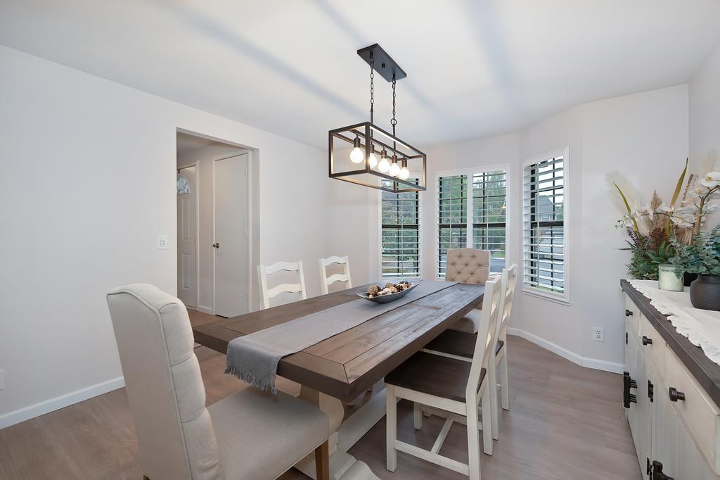 8477 Rick Mary Court Fair Oaks, CA 95628 - Photo 11 of 48 a view of a dining room with furniture window and wooden floor