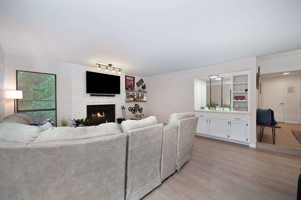 8477 Rick Mary Court Fair Oaks, CA 95628 - Photo 16 of 48 a living room with furniture a fireplace and a flat screen tv