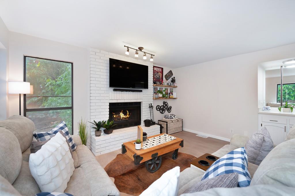 8477 Rick Mary Court Fair Oaks, CA 95628 - Photo 17 of 48 a living room with furniture a flat screen tv and a fireplace